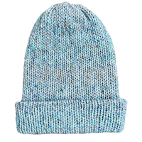 a blue knitted beanie on a black background